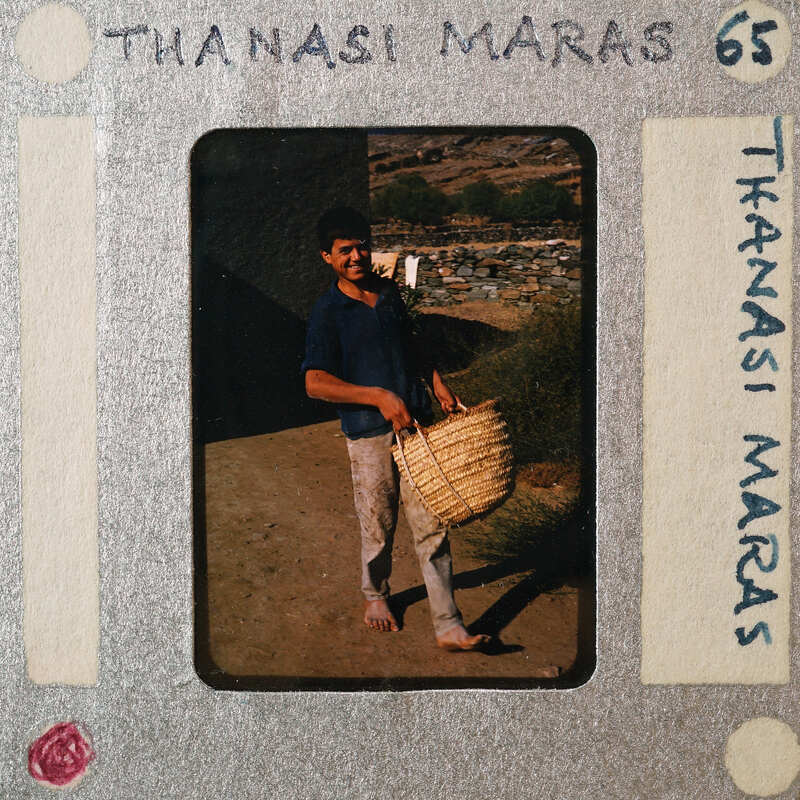 A man standing outside holding a basket.