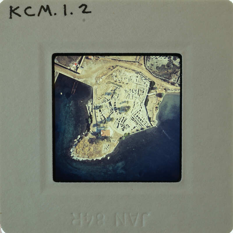 Aerial photograph of a coastal area with buildings and water.