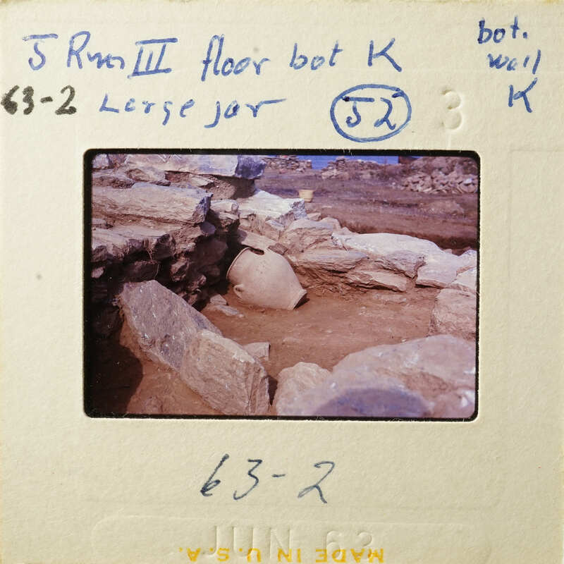 Archaeological site with ancient pottery and stone ruins.