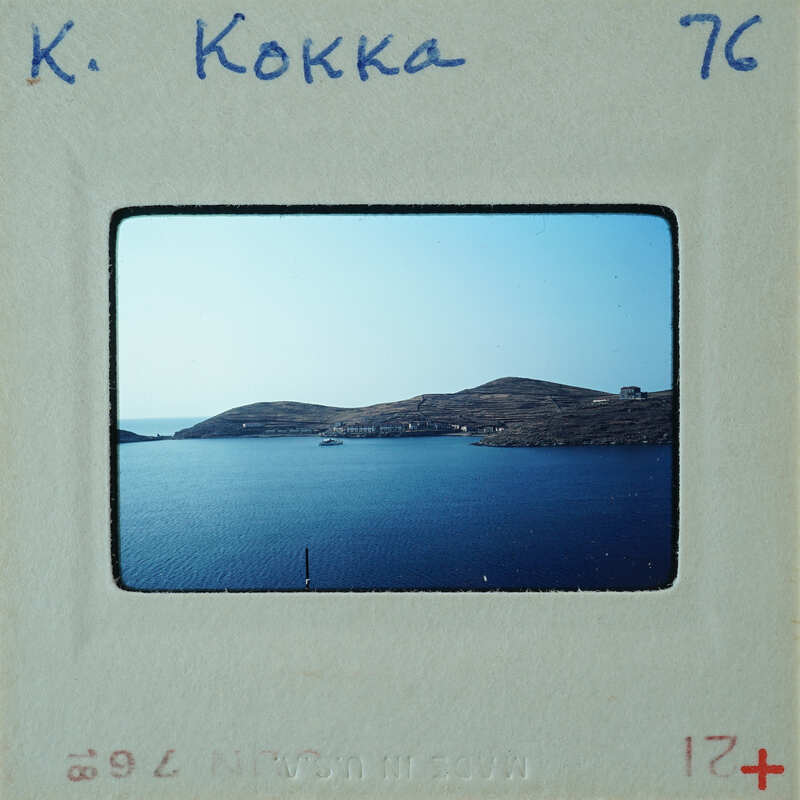 A vintage photo of a serene body of water with islands and boats, featuring an old-fashioned Polaroid frame.