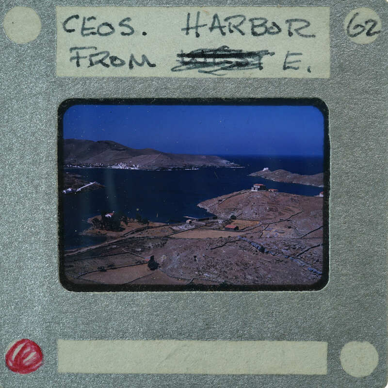 A vintage film strip with a scenic view of an island and ocean.