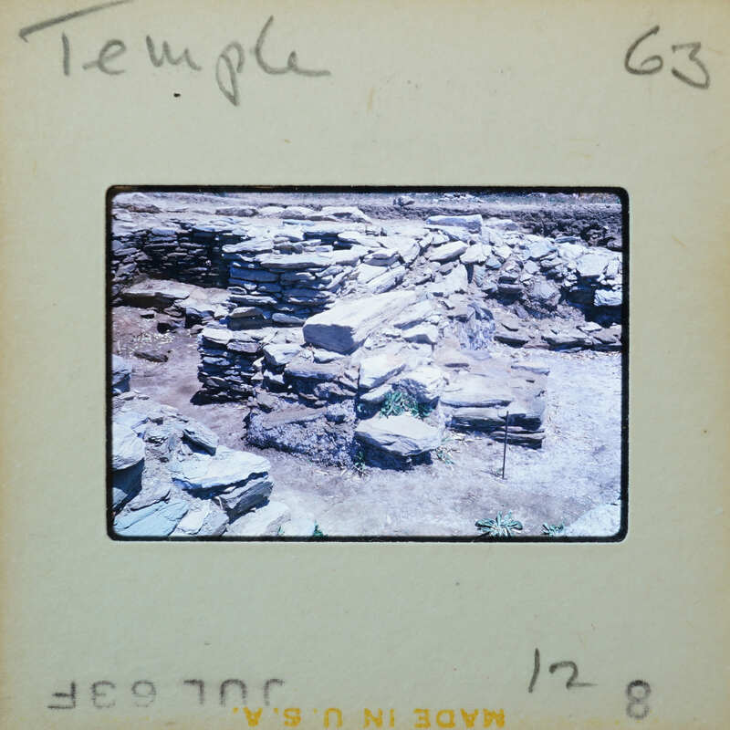 Details of temple stone wall with doorway on the lower left.