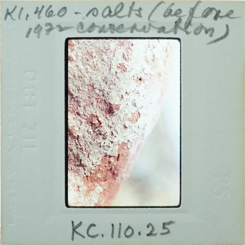 A close-up image of a rusty metal surface with an old Polaroid photo label on it.