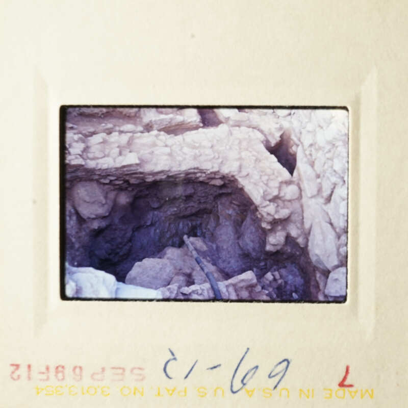 This is an image of a cave entrance with a small tunnel leading into it.