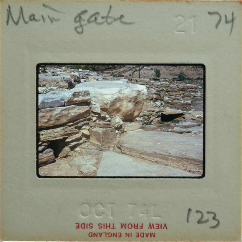 Old photograph of a rocky landscape with a film strip label on it.
