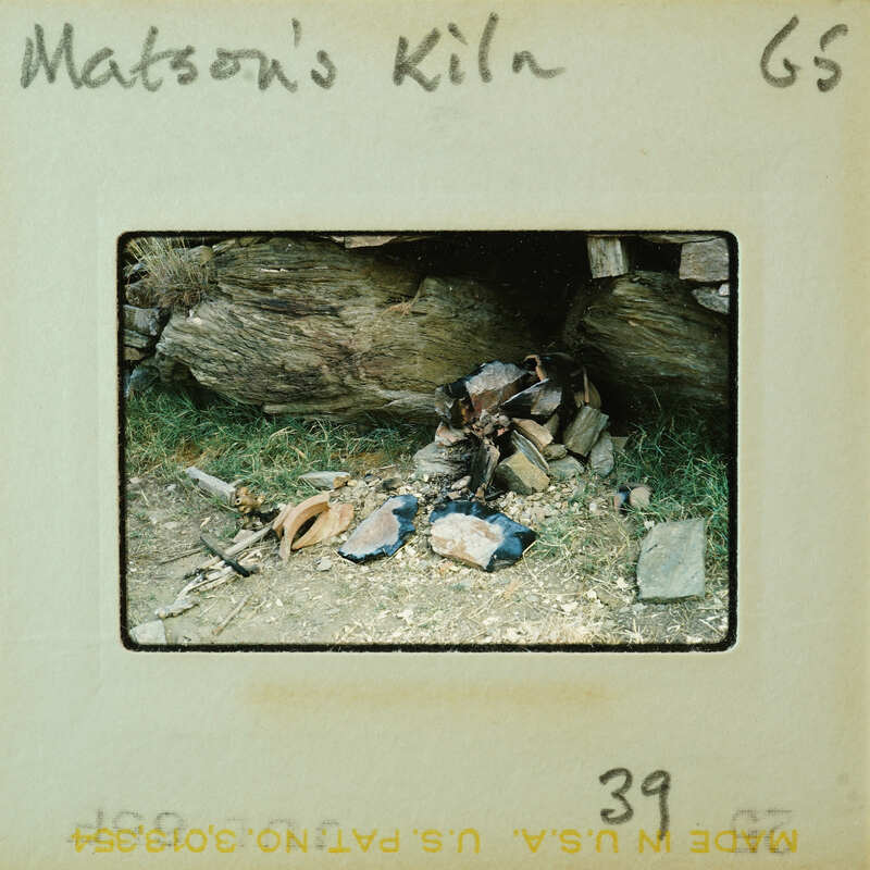 Old photograph of a pile of rocks with grass and dirt, labeled "Matson's Kiln" on the negative strip.