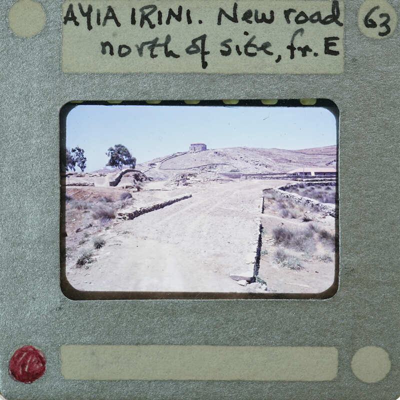 A film strip with a photograph of a dirt road and rocky terrain.