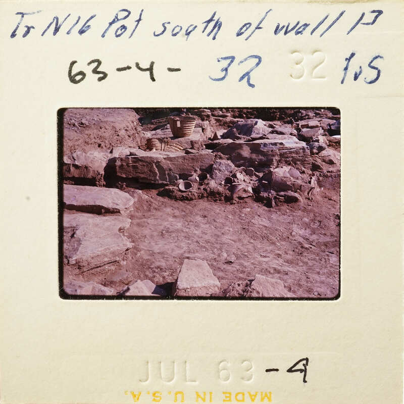 Photo of an archaeological site with ruins and stones.