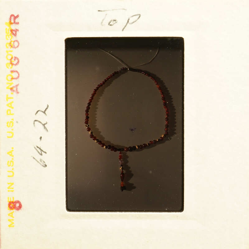 Red beaded necklace on display.