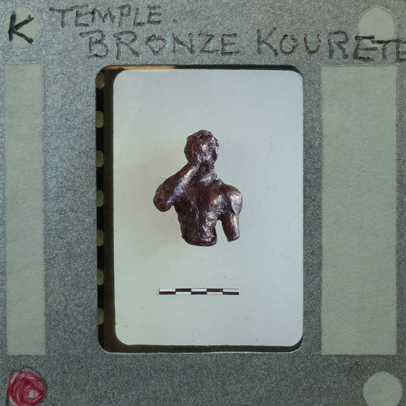 A bronze sculpture of a man with his hand over his mouth, displayed on a card.