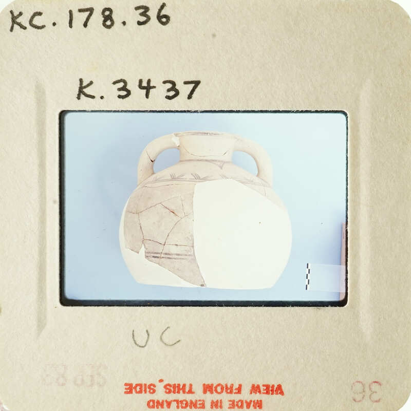 Ancient vase with visible cracks and missing pieces on a blue background.