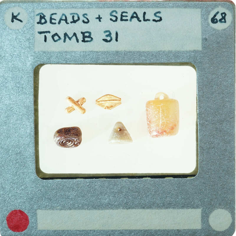 A collection of small objects, including beads and seals, on white background.