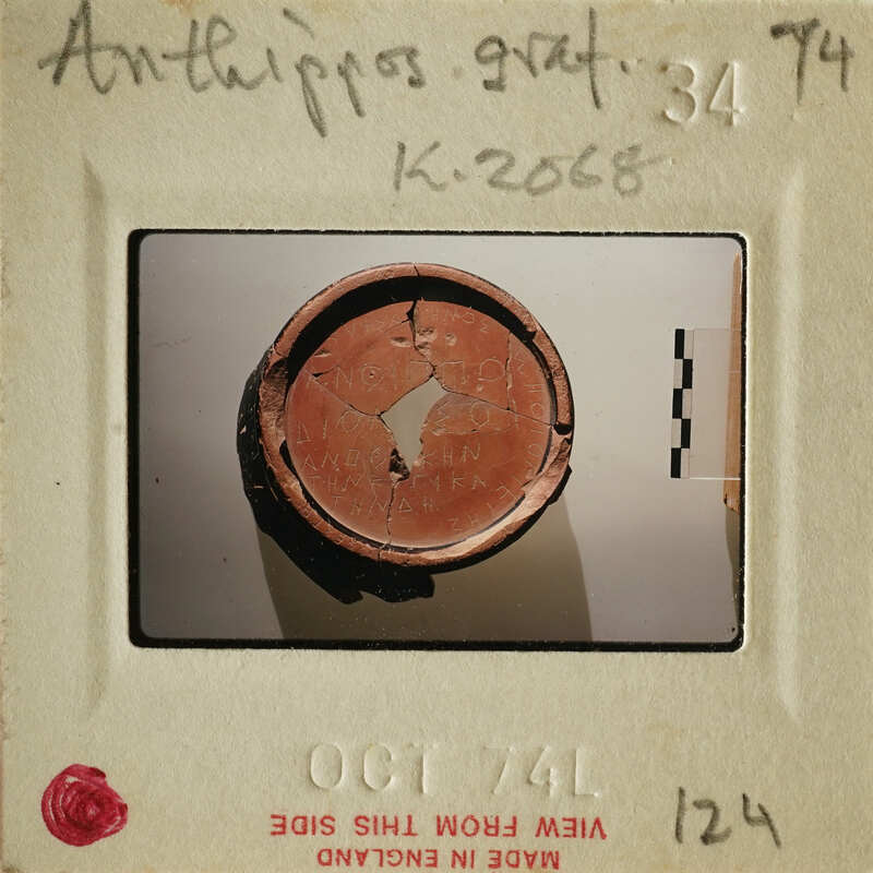 A photograph of an ancient sherd with visible cracks and damage, taken on October 7, 1974.