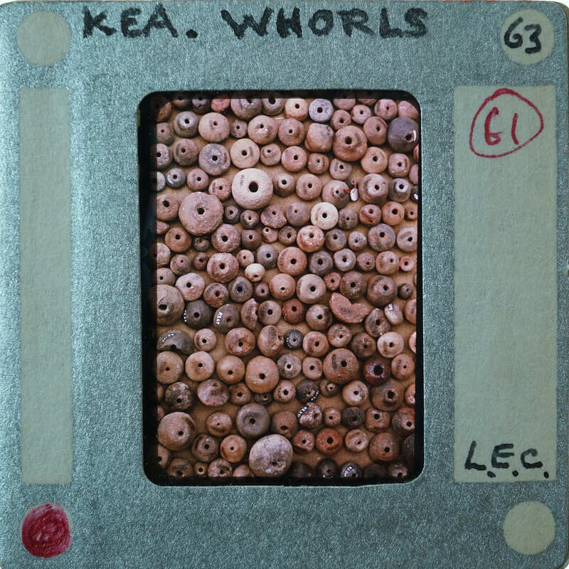 Large assortment of round clay objects with holes in them from the top.