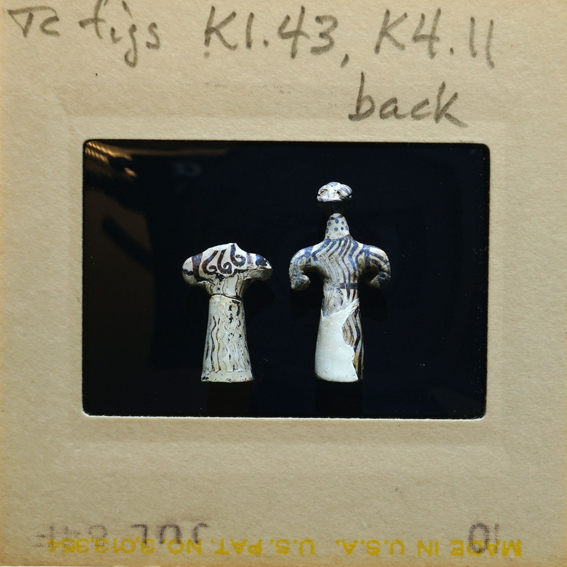 Two small reconstructed figurines showing dark paint on white surface, K1.43, K4.11.