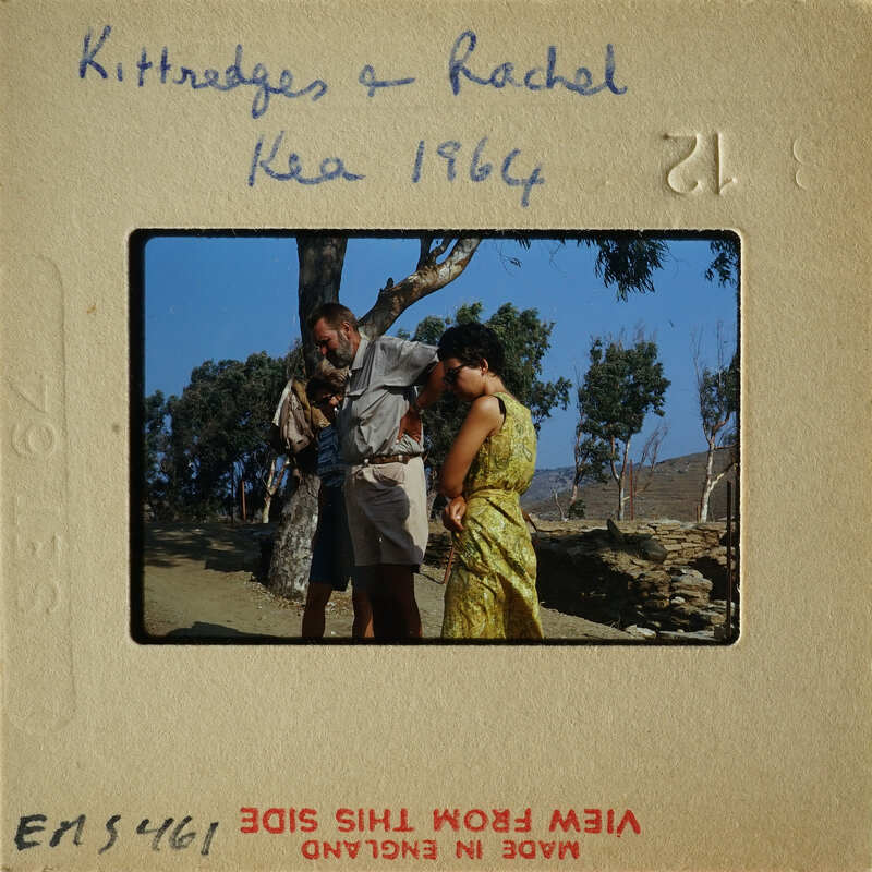 Couple standing together with trees and mountains in the background.
