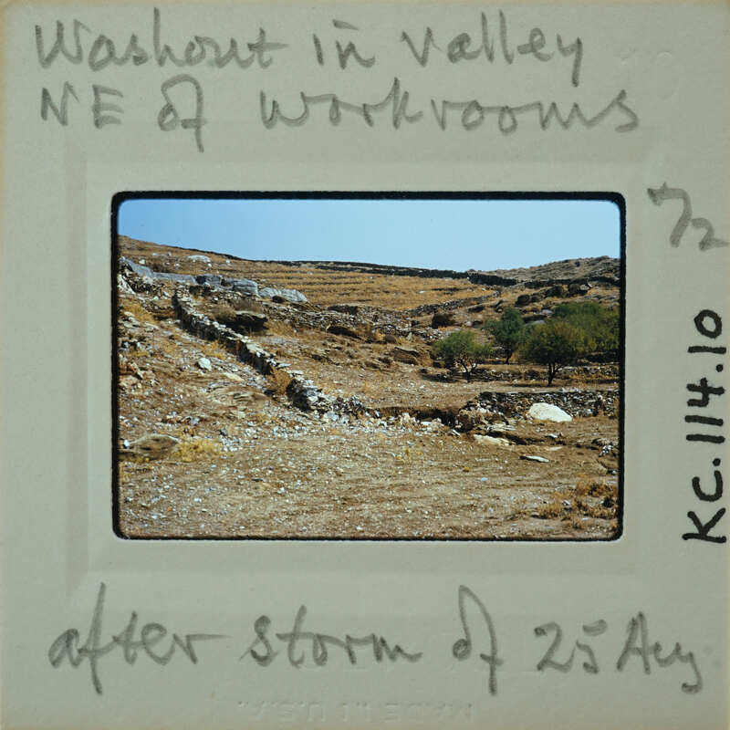 An old photograph of a desert landscape with hills and sparse vegetation, taken on July 14th, 1975 after a storm.