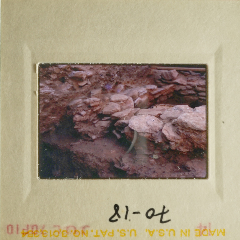 Slide with photo of rocky hillside and ruins.