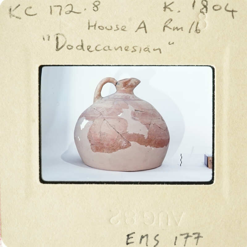 Ancient Greek vase with map-like design on display.