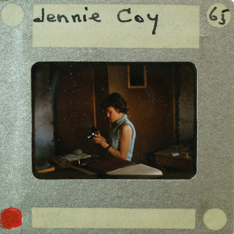 A vintage photograph of a woman with a film strip border.