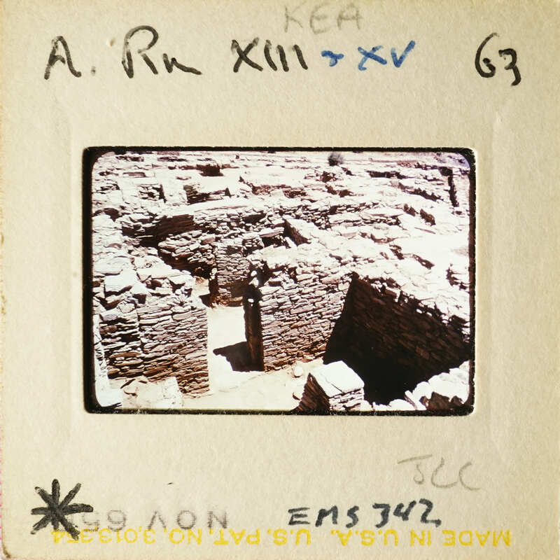 Old photograph of ruins, possibly ancient city walls or buildings with stone blocks and columns.