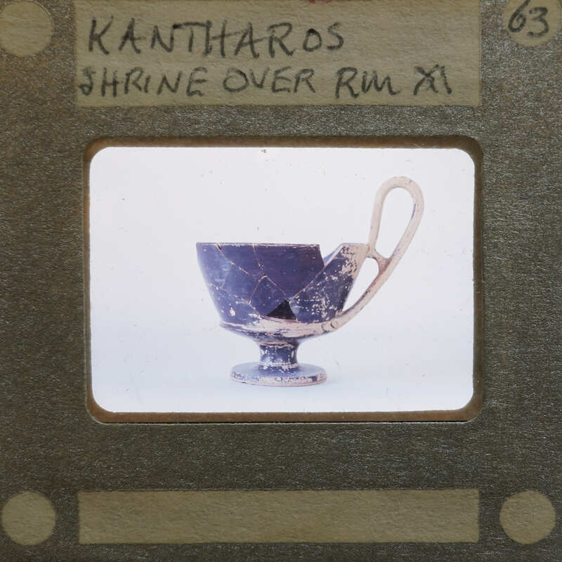 Reassembled katharos style cup with large handle in profile.