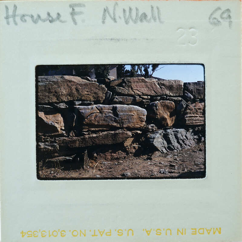 A vintage film strip with a photograph of a rock wall on it.