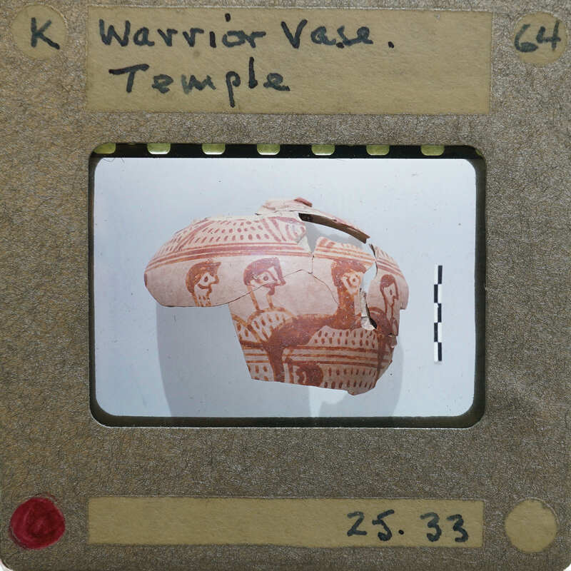 Partially reassembled vase with warrior motif in red paint.