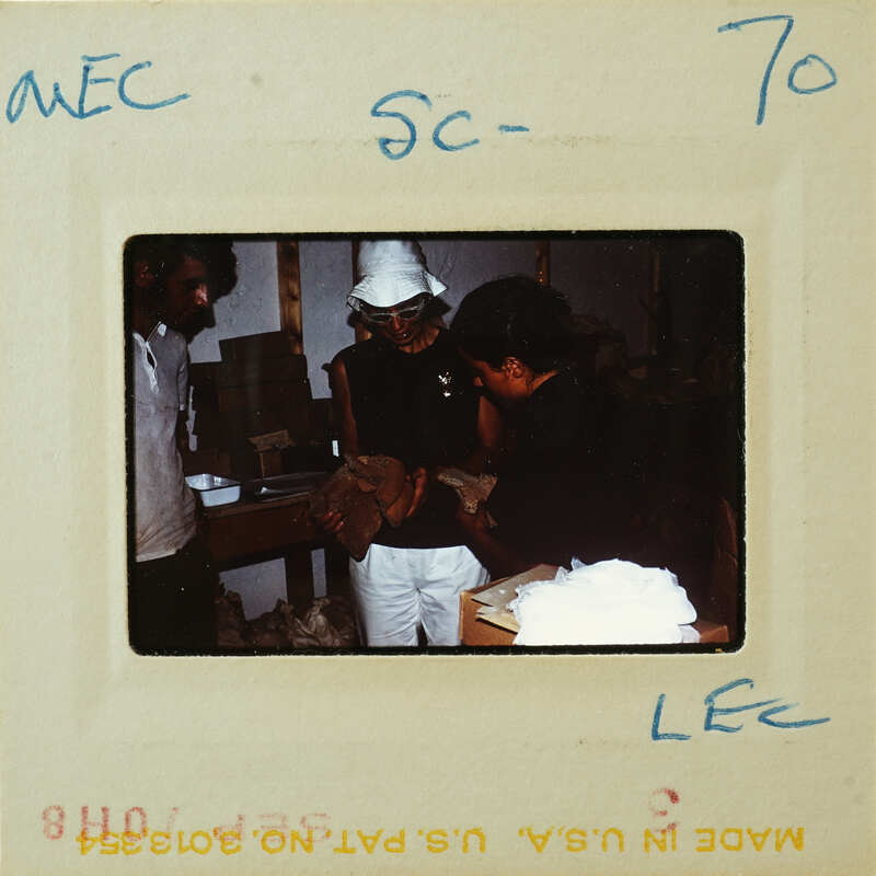 A vintage photo of a person with a hat and another individual, possibly taken from an old film reel.