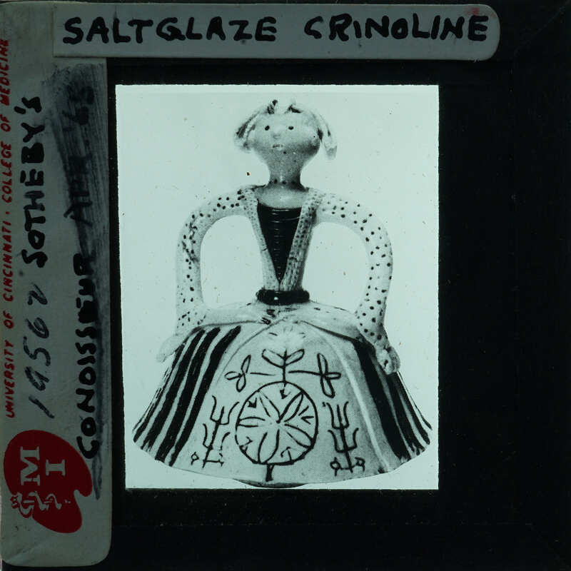 Black and white image of a ceramic figurine with a label on it.