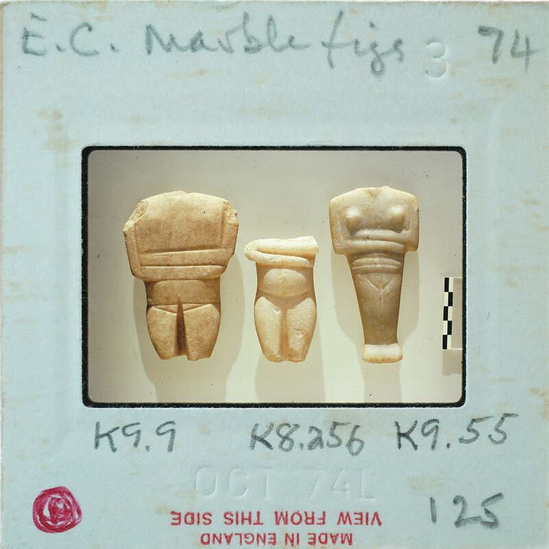 Three small stone figurine torsos on a table, K9.9 K8.256 K9.55.
