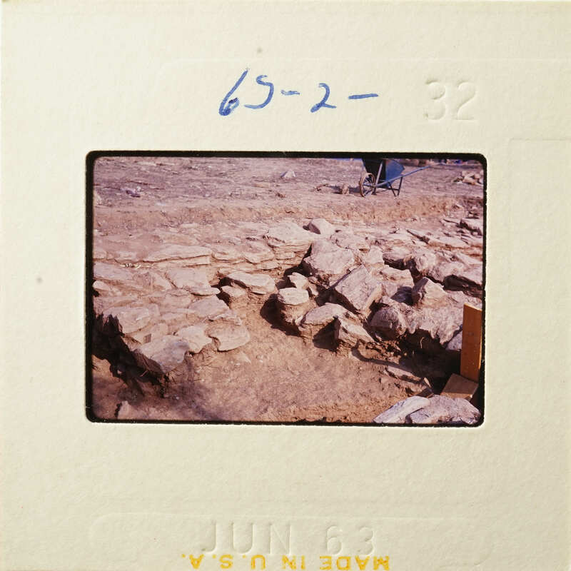 Old photograph of stone ruins with handwritten numbers and date on border.