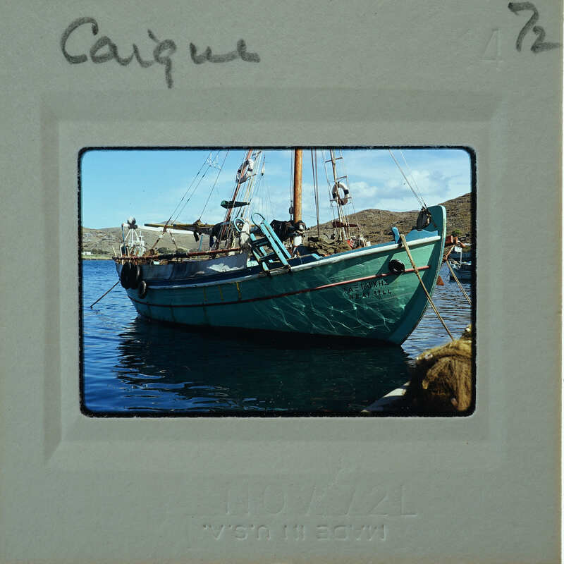 A vintage photo of a boat on water, with handwritten notes and numbers on the border.
