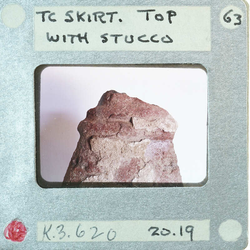 Terracotta figurine detail showing top of skirt.