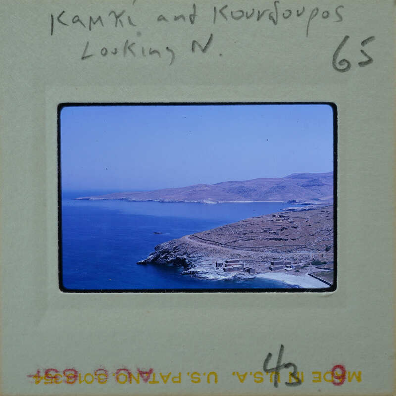 A photograph of a scenic coastal landscape with mountains and the ocean.