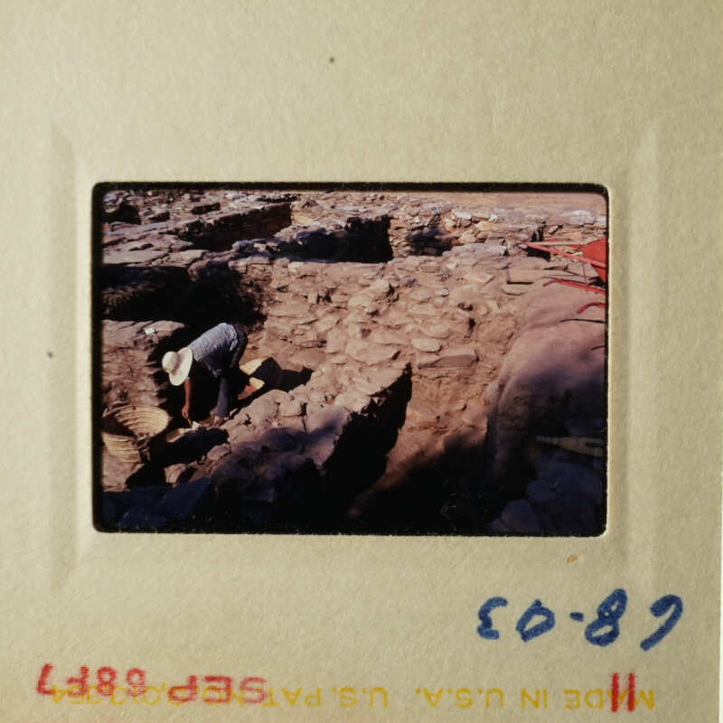 Archeological site with two people working on excavation.