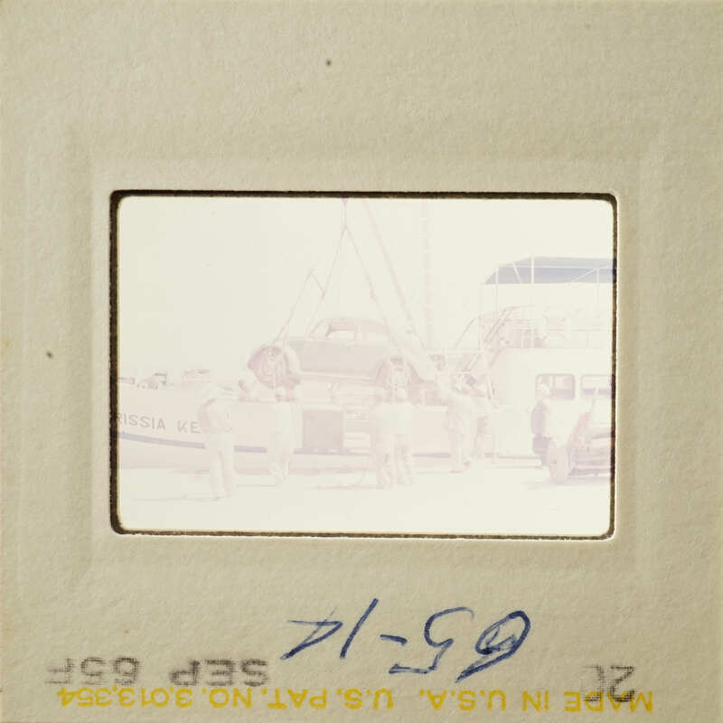 People standing near boats on a dock.