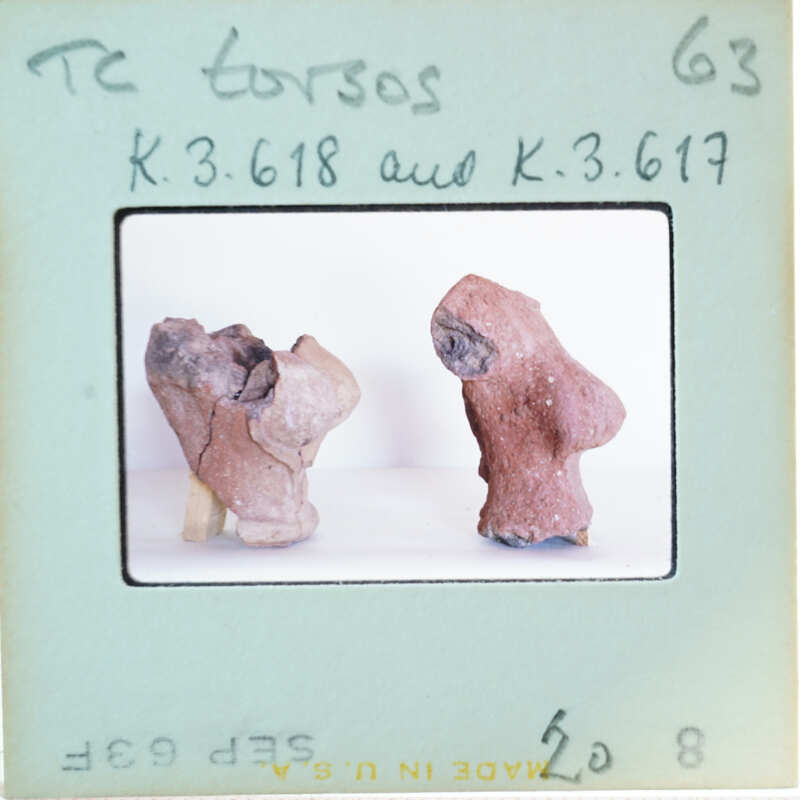 Two ancient clay figurines on display.