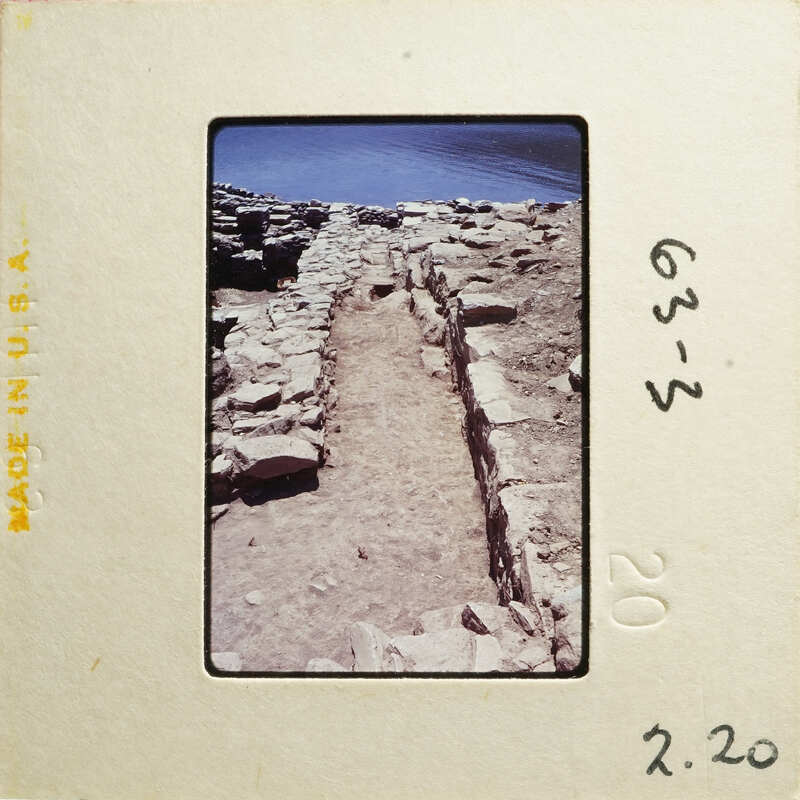 Stone steps leading down to water, with rocks and dirt on either side.