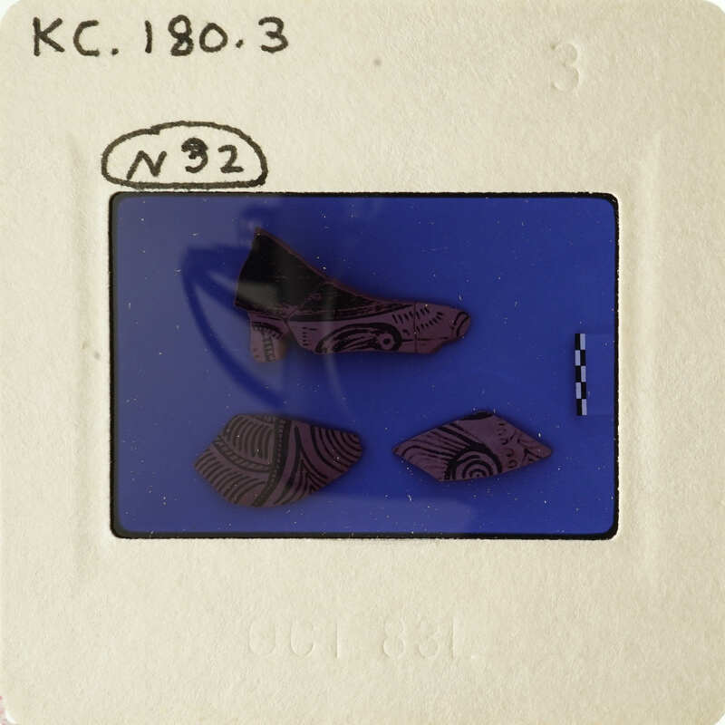 A photograph showing three ancient pottery shards with intricate designs.