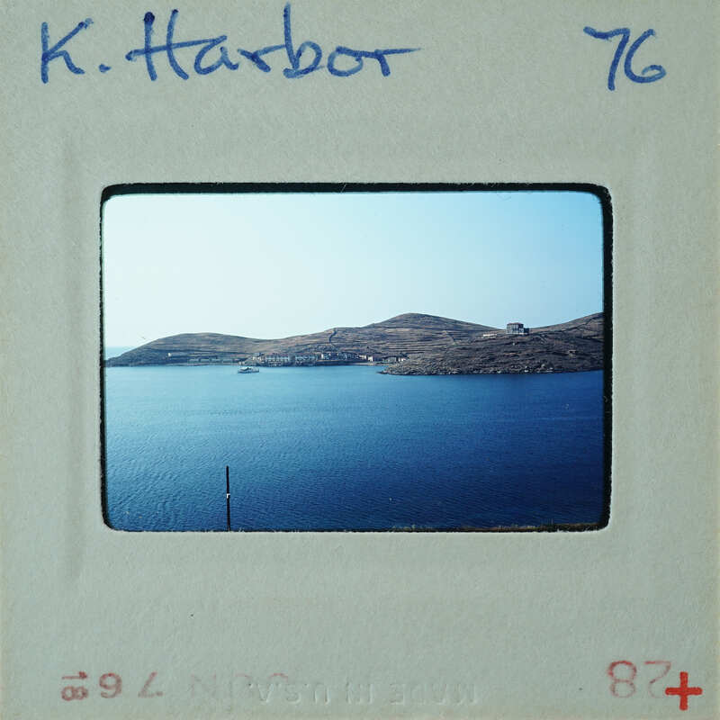 Picture of water with island and boat, taken from a high vantage point.