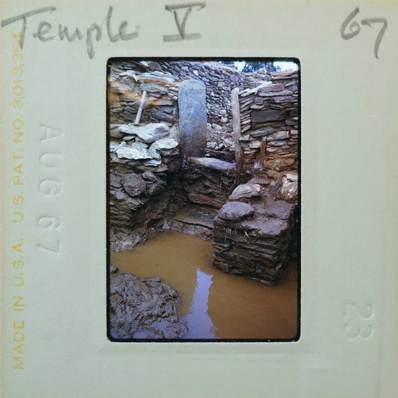 Old stone ruins with a muddy water feature.