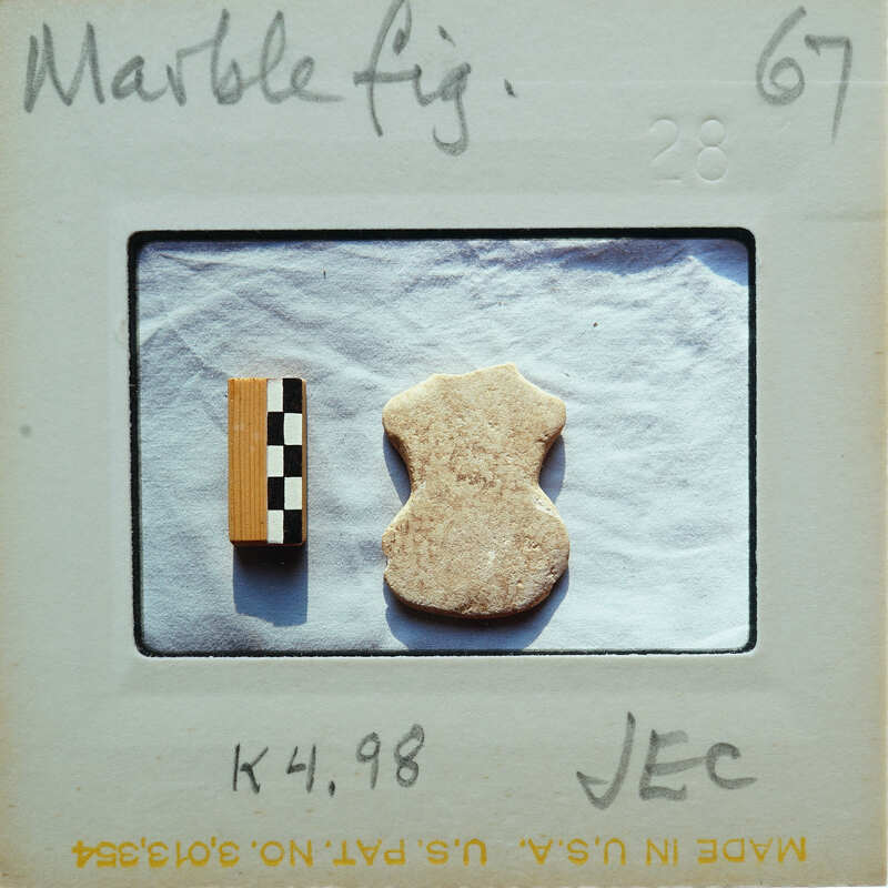 A small marble figurine next to a scale.