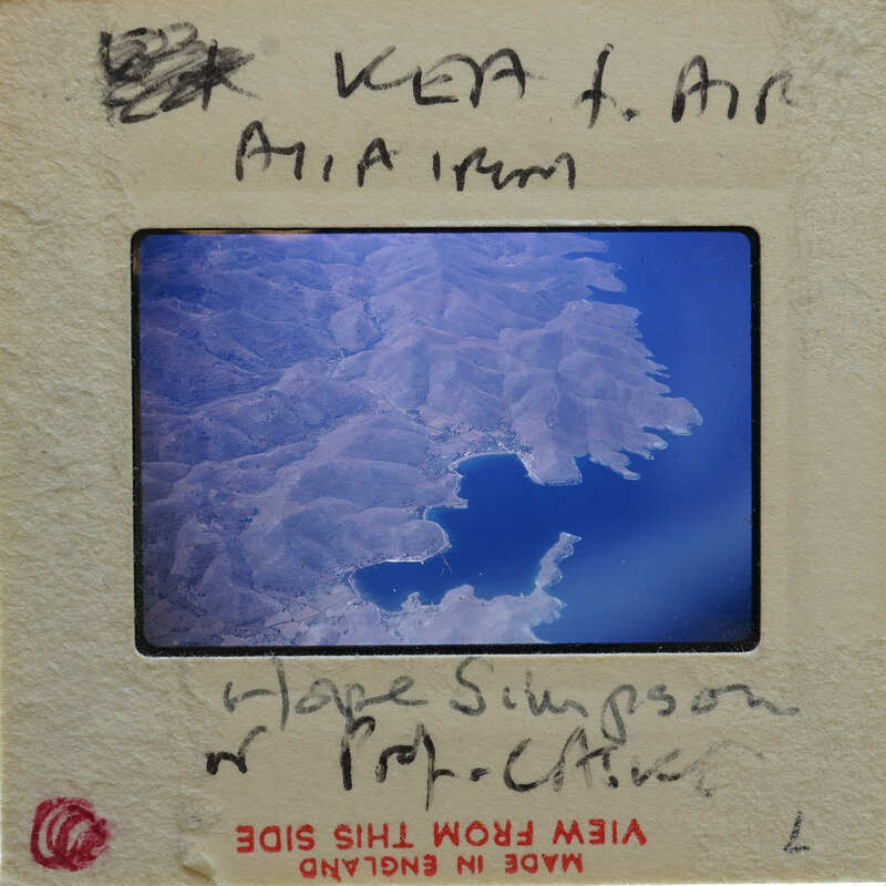 Aerial photograph of a mountainous landscape with a body of water.