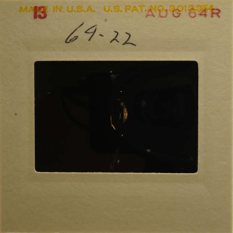 Old photograph with a yellowed frame and a red stamp on the top left corner.