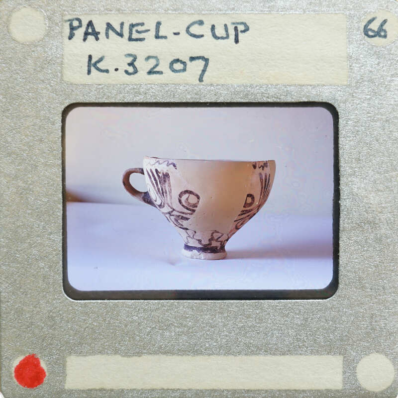 A panel cup (K.3207) in profile with handle.