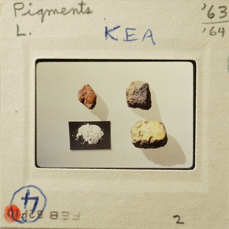 Photograph of four samples with labels, possibly minerals or substances on display.
