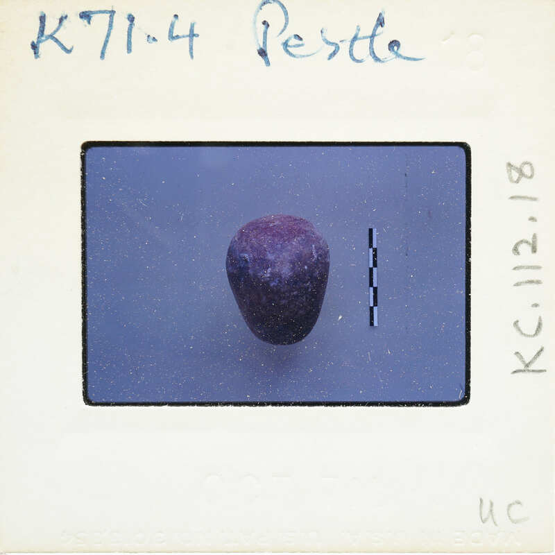 Small, dark purple gemstone with a rough surface.