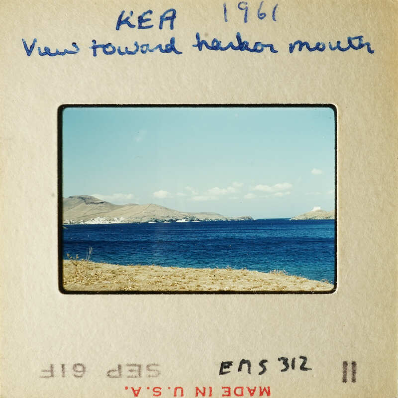 View towards harbor mouth with blue ocean and distant land.