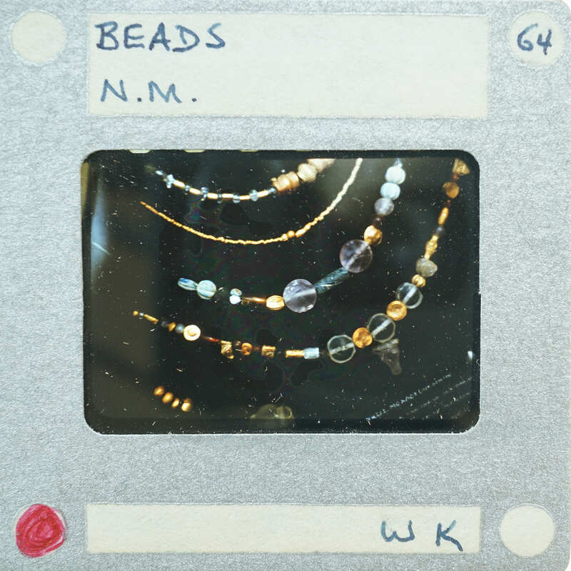 A close-up photo of a necklace with beads.